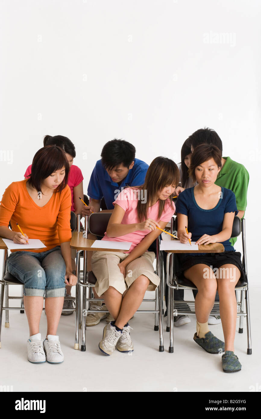 Group of college students giving exam in a classroom Stock Photo