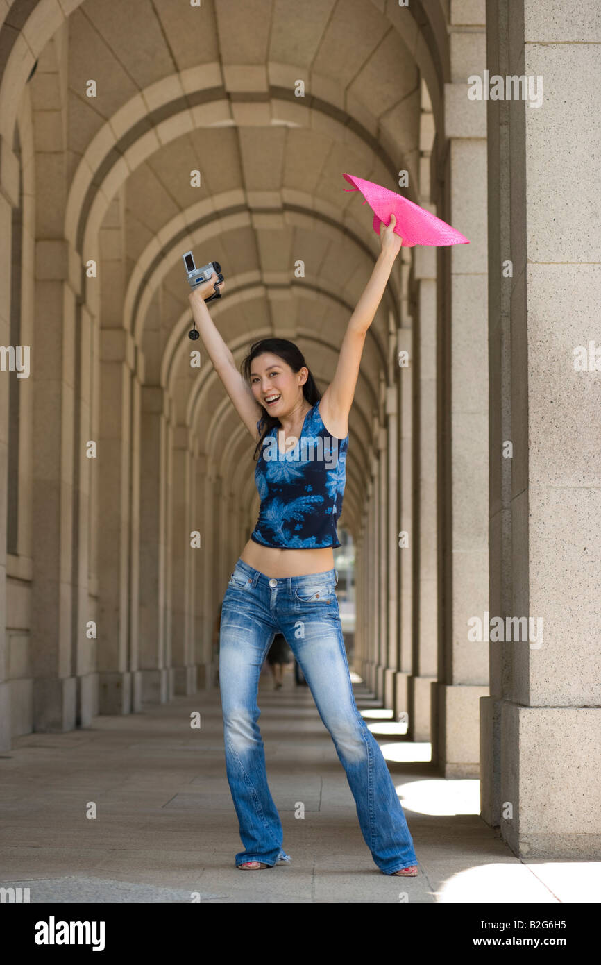 Portrait of a young woman holding a home video camera and smiling Stock ...