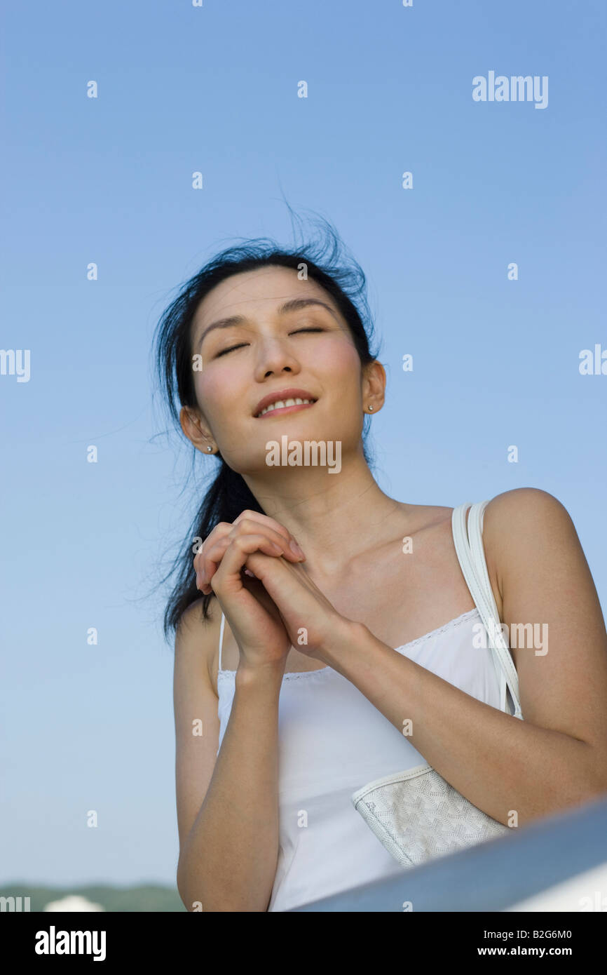 Woman praying eyes closed hi-res stock photography and images - Alamy