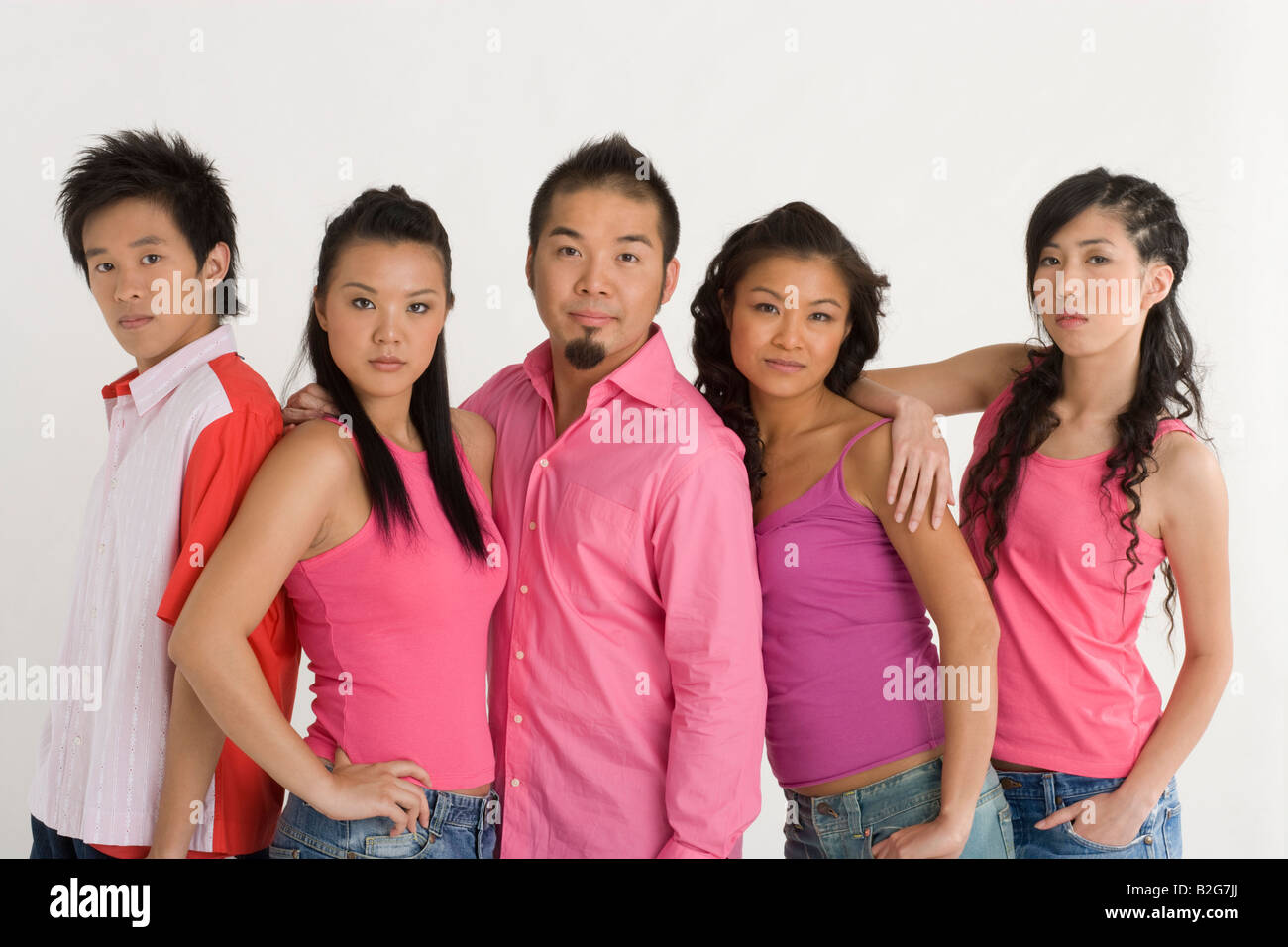 Two young men with three young women standing together Stock Photo - Alamy