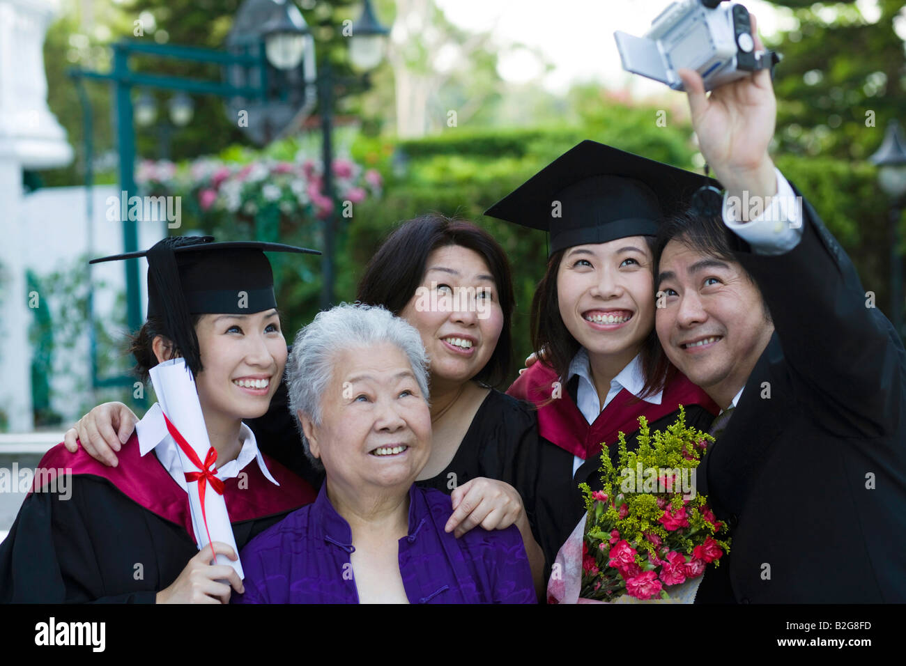 Family Using Filming Camera Family filming themselves with a home video camera Stock Photo - Alamy