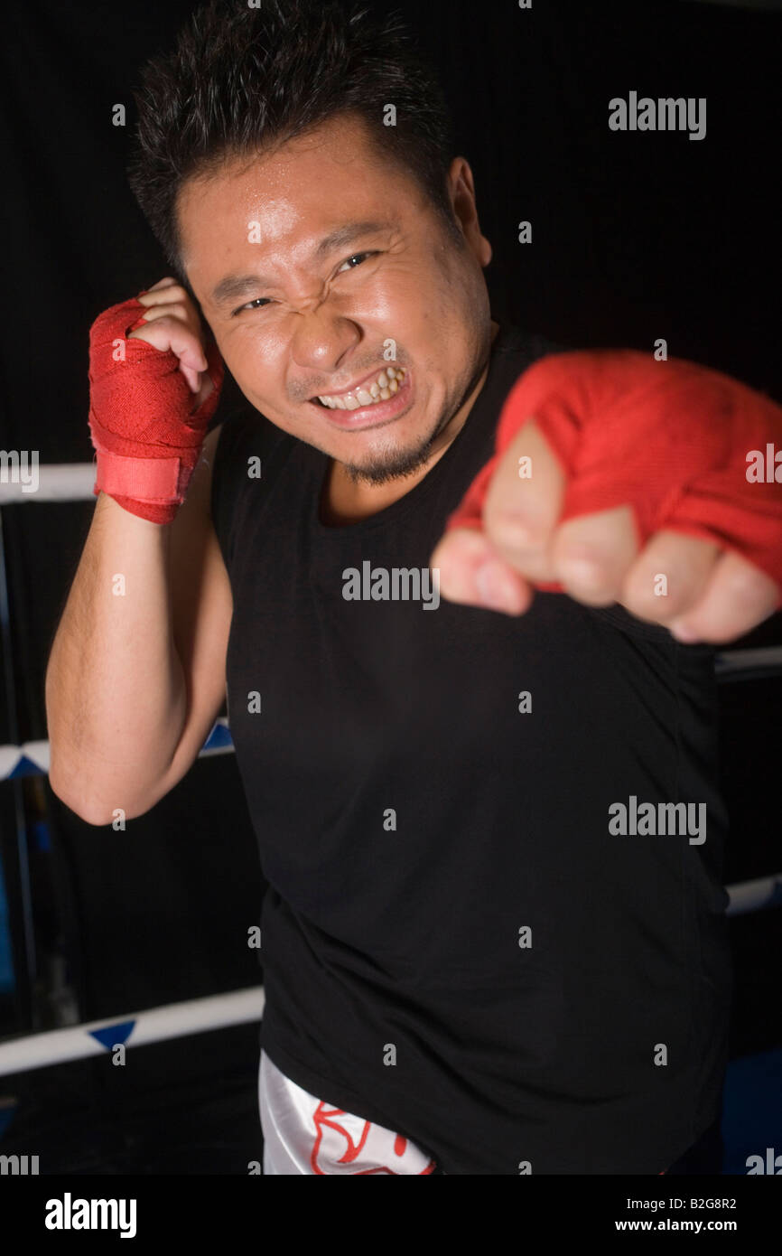 Mid adult man practicing boxing in a boxing ring Stock Photo - Alamy