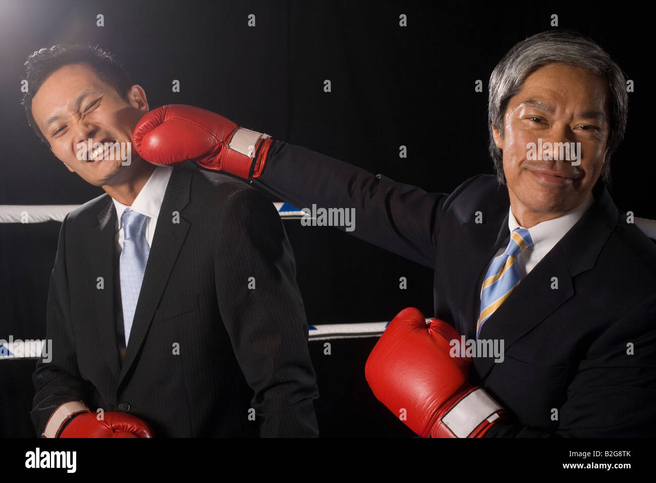 Two businessmen fighting in a boxing ring Stock Photo