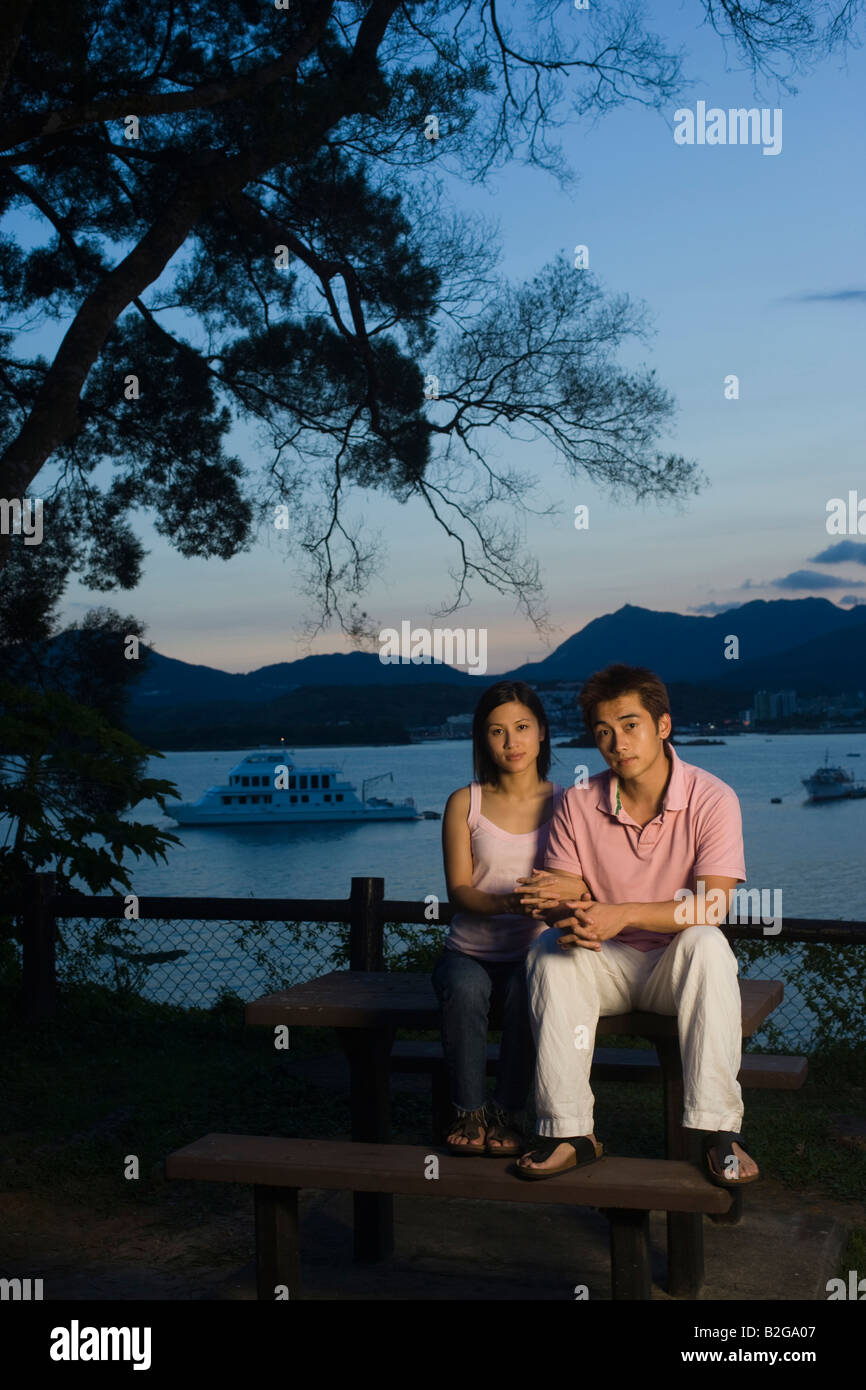 Portrait of a couple sitting on a bench at the seaside Stock Photo - Alamy