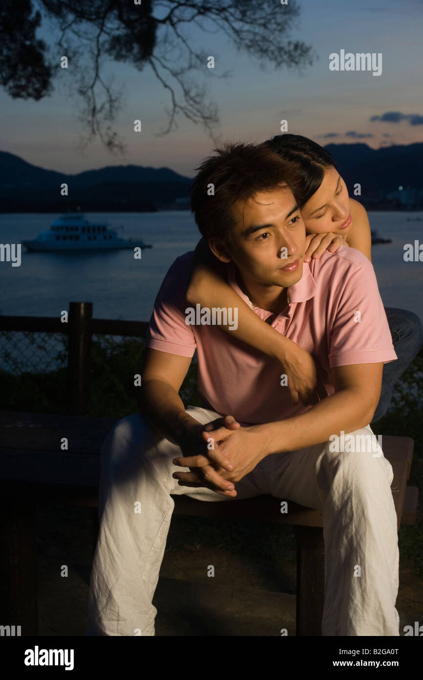 Mid adult woman embracing a young man from behind Stock Photo - Alamy