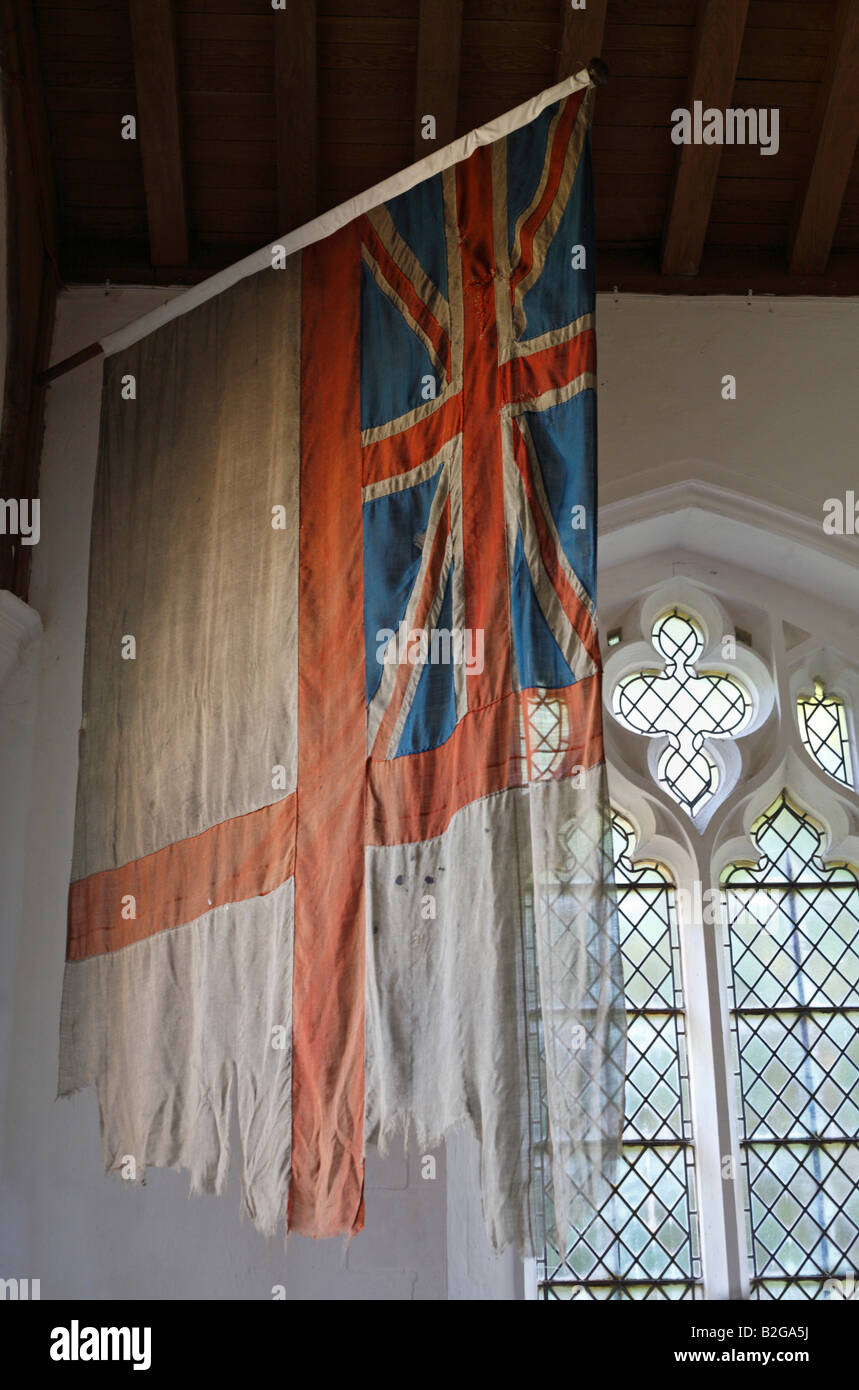 White Ensign flag from H.M.S. Indomitable hanging in All Saints Church at Burnham Thorpe in Norfolk, England. Stock Photo