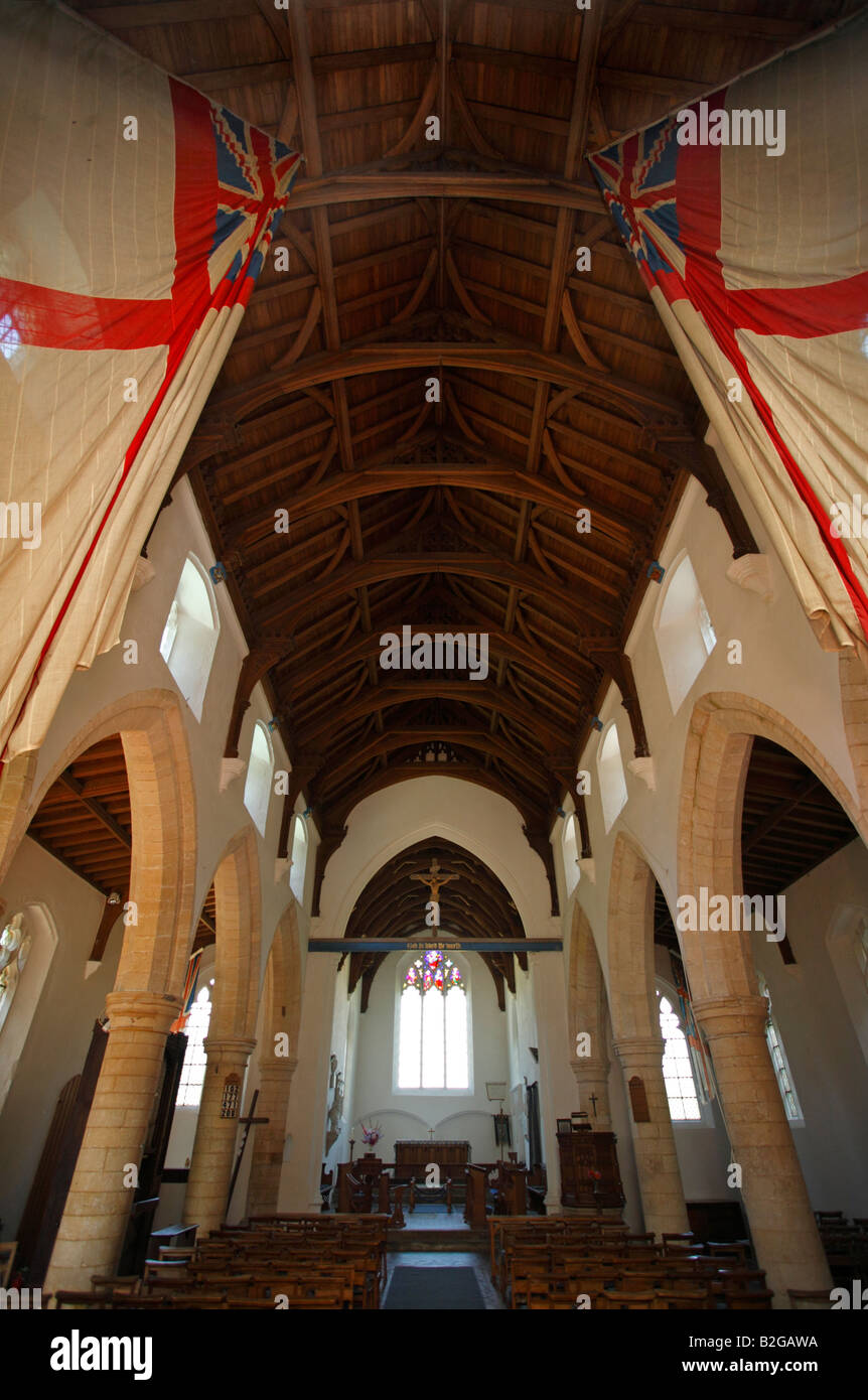 White Ensign flags from HMS Nelson hanging inside All Saints Church at Burnham Thorpe, Norfolk. Stock Photo