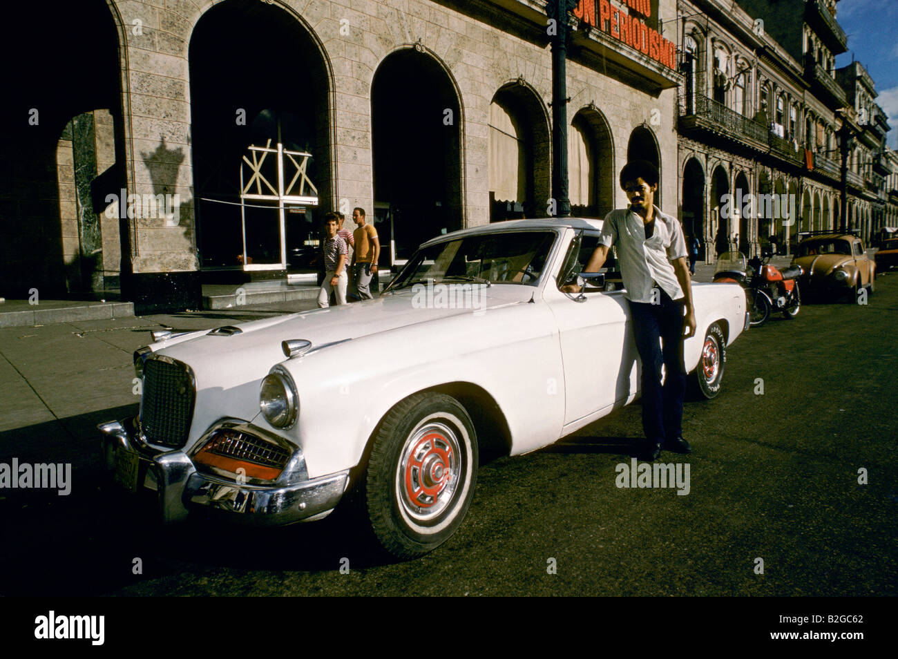 Man Standing Next To His White Classic American Car Parked In A Street In Havana Cuba Stock Photo Alamy
