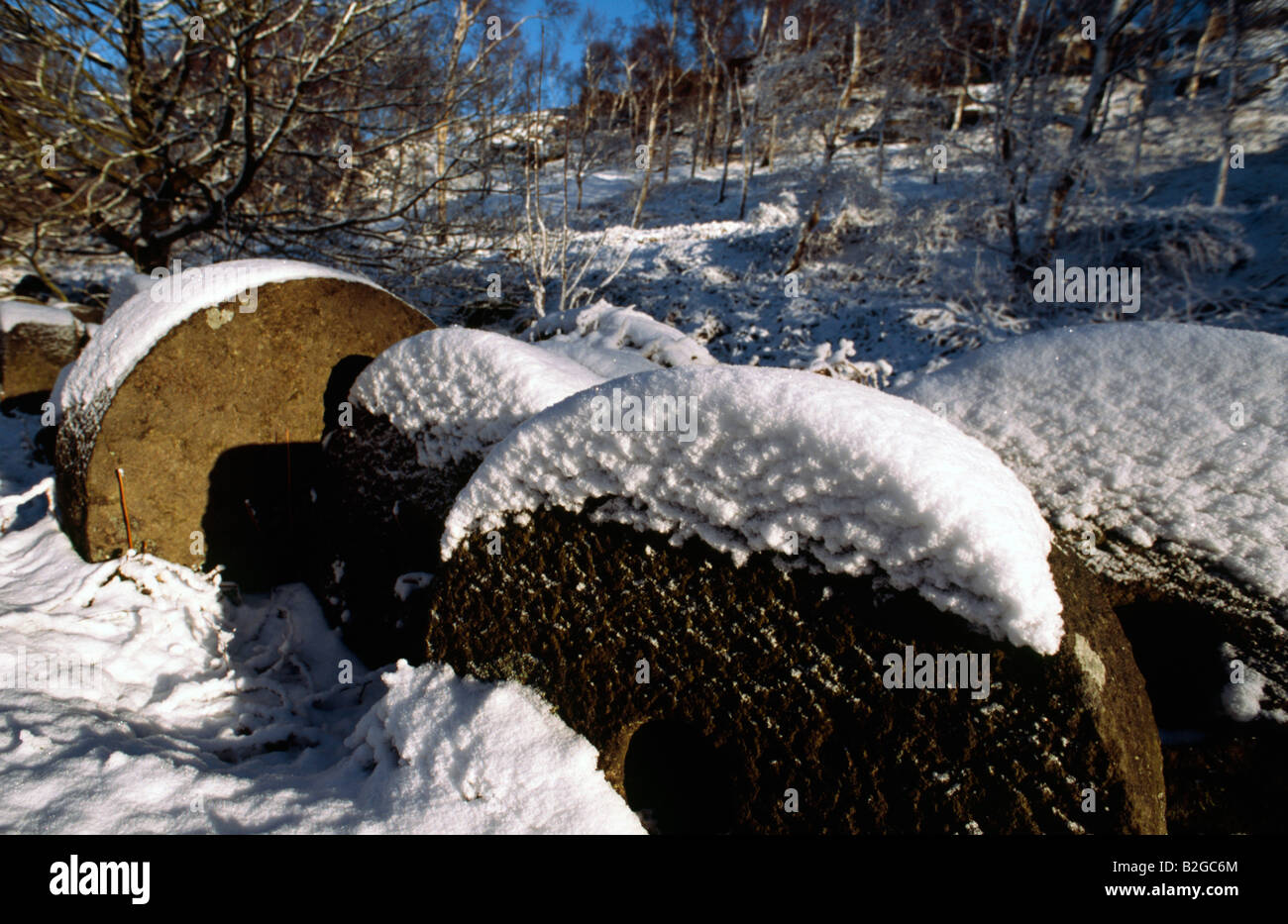 Millstones in the winter snow Peak District National Park Derbyshire Stock Photo