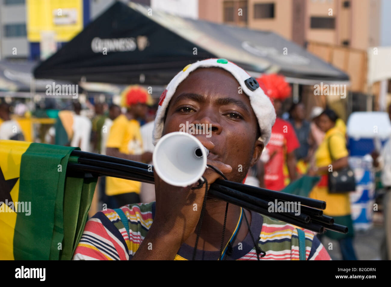 Man selling flags and vuvuzela horns for Africa Cup of Nations 2008 Accra Stock Photo