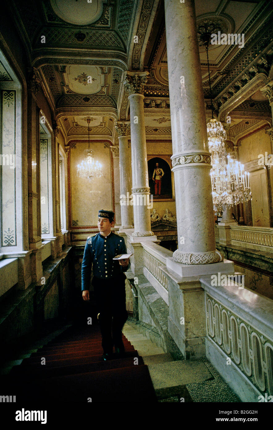 a bellboy climbs the marble staircase of the imperial hotel vienna Stock Photo