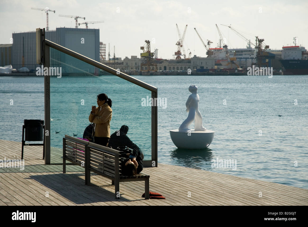 Rambla de Mar Port Vell bridge two people on a bench Barcelona Stock Photo