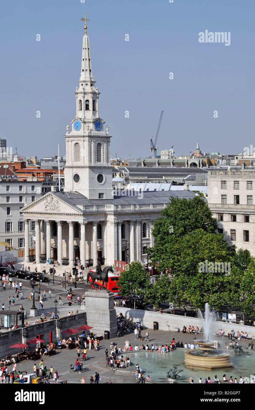 Looking down on St Martin in the-Fields church & tourist visitors in and around Trafalgar Square includes one fountain London England UK Stock Photo