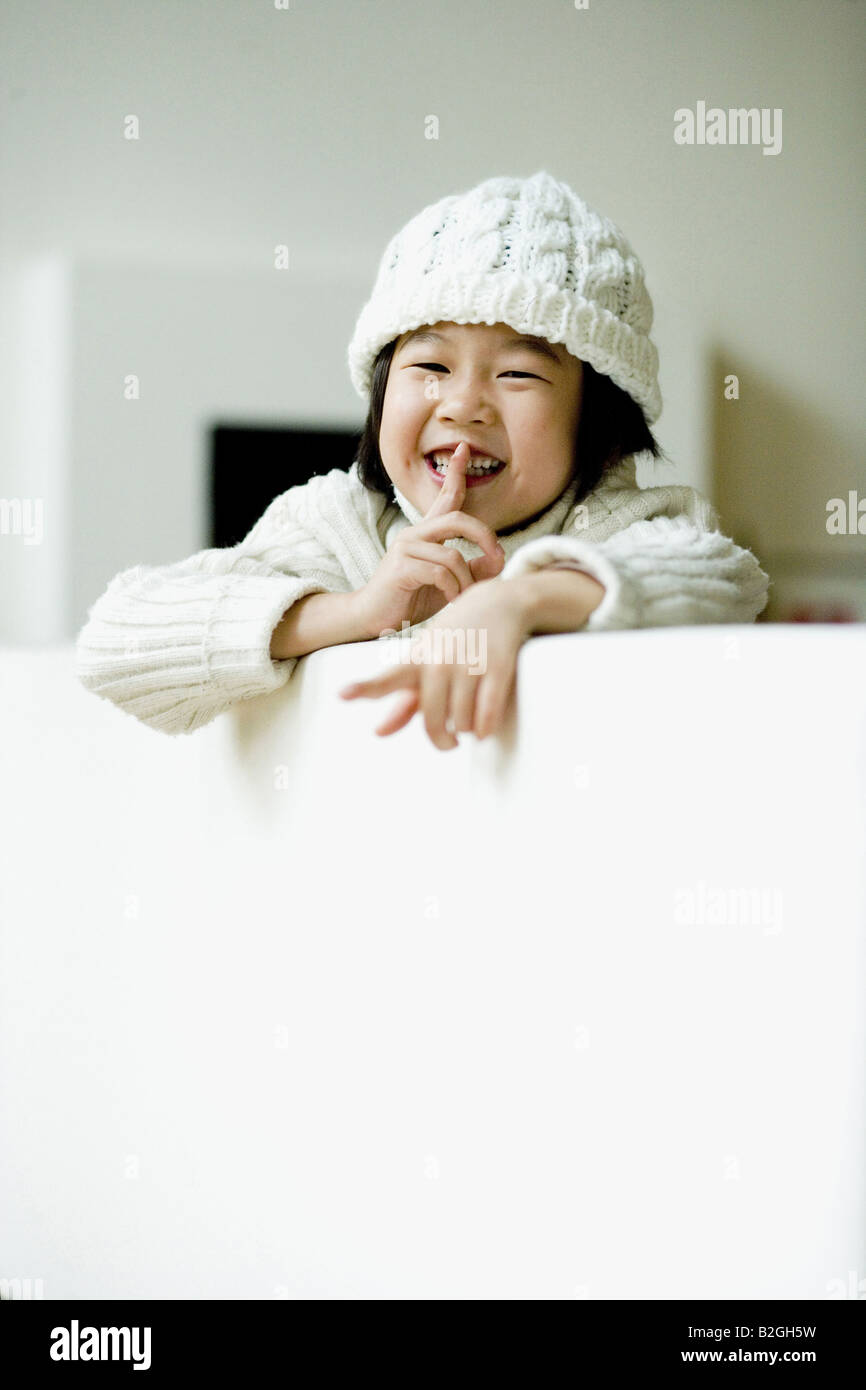 Portrait of a girl with finger on lips Stock Photo - Alamy