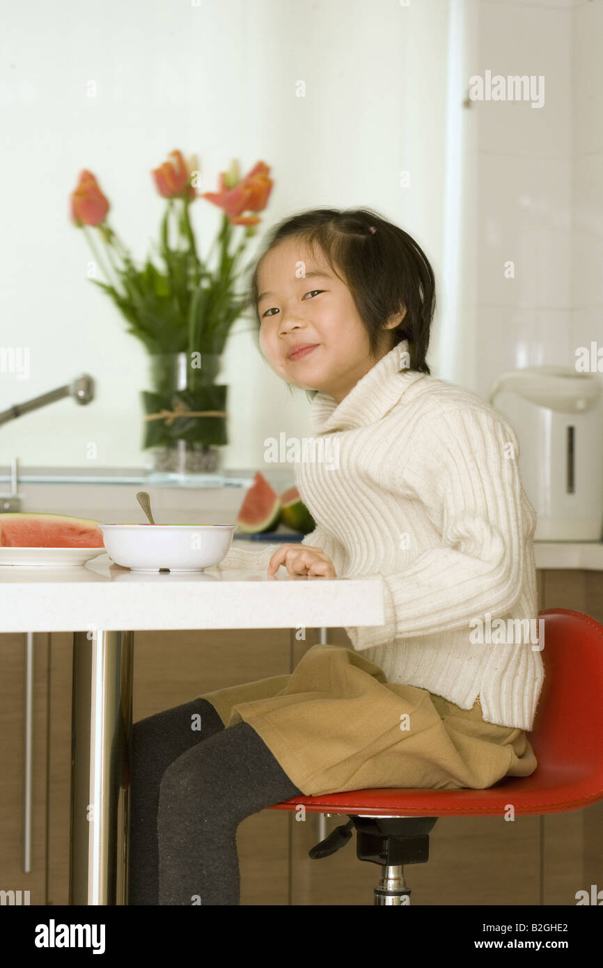 Girl sitting on chair smiling hi-res stock photography and images - Alamy