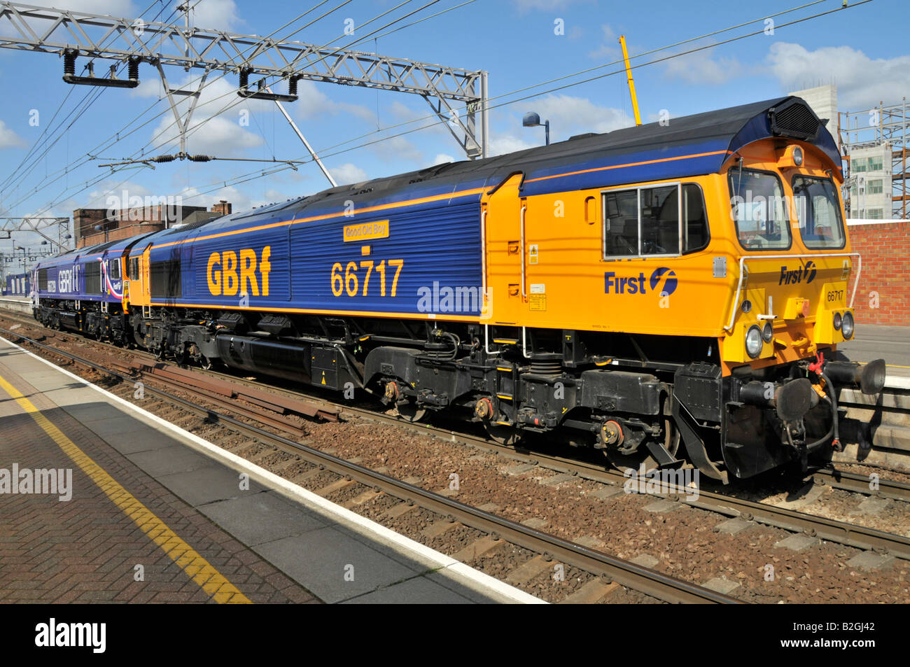 Diesel freight locomotive 66717 named Good Old Boy in first GBRf livery running light with 66729 seen at Stratford East London Stock Photo