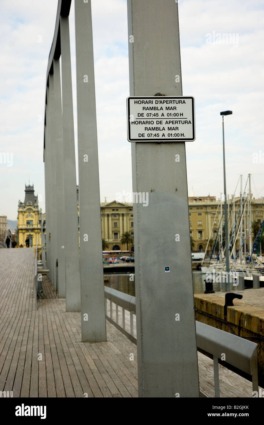 Rambla de Mar Port Vell bridge hours sign Barcelona Spain Stock Photo