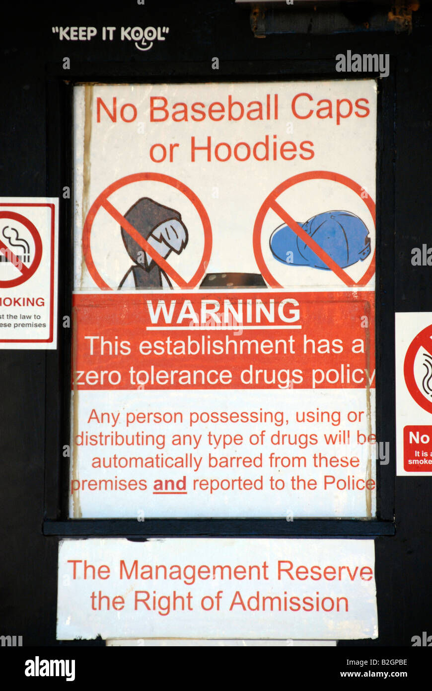 Warning sign on pub door anti hoodies  drugs  baseball caps. Stock Photo