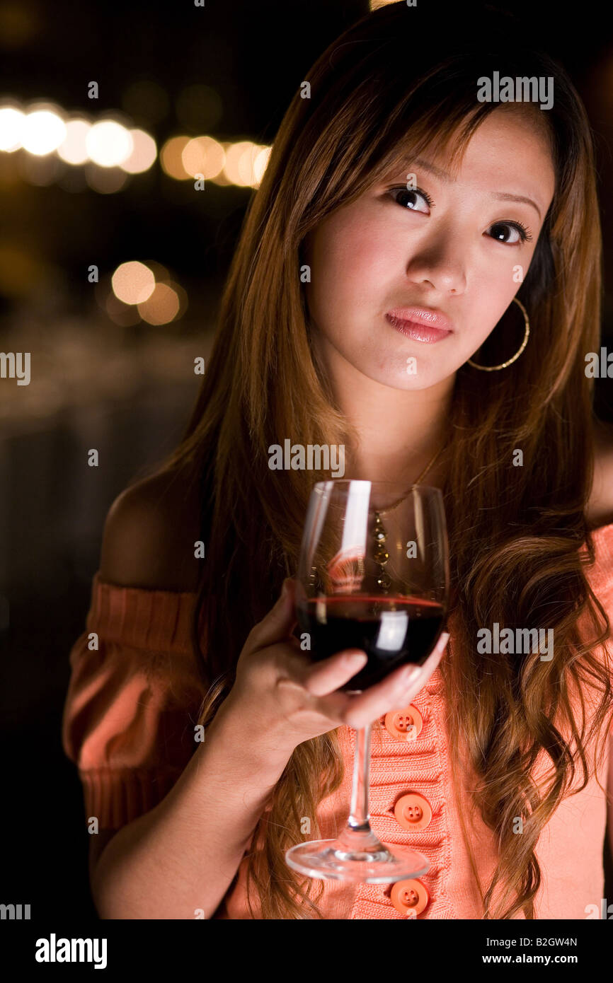 Portrait of a businesswoman holding a glass of wine Stock Photo - Alamy