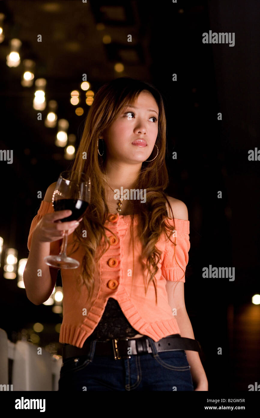 Businesswoman holding a glass of wine in a bar Stock Photo - Alamy