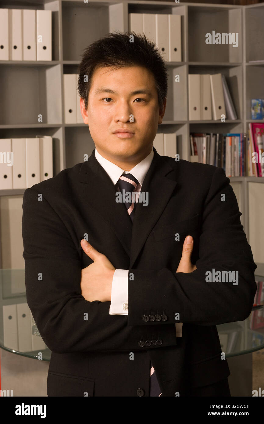 Portrait of a businessman standing with his arms crossed in an office ...