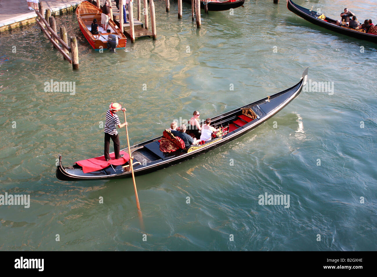 Tourists enjoying a gondola tour of the Venetian canals Stock Photo