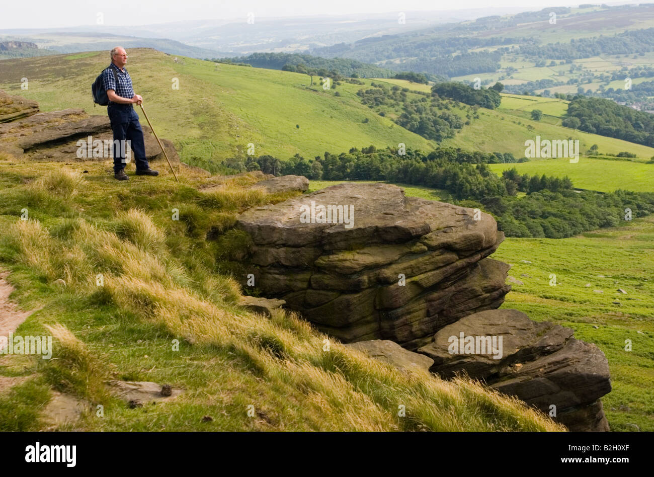A hill walker viewing the countryside. England, UK Stock Photo