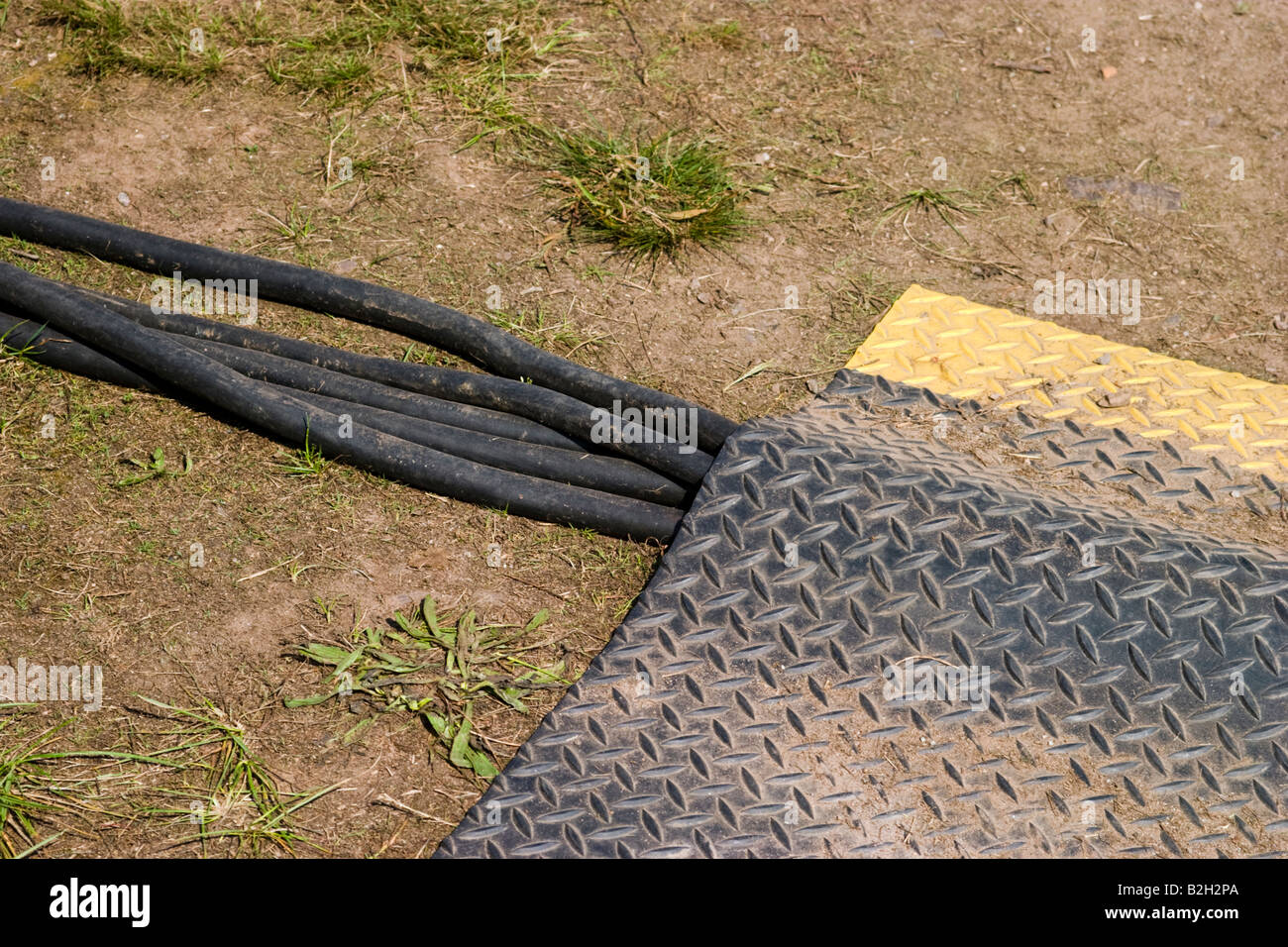 Electrical cables partially covered with a mat Stock Photo - Alamy