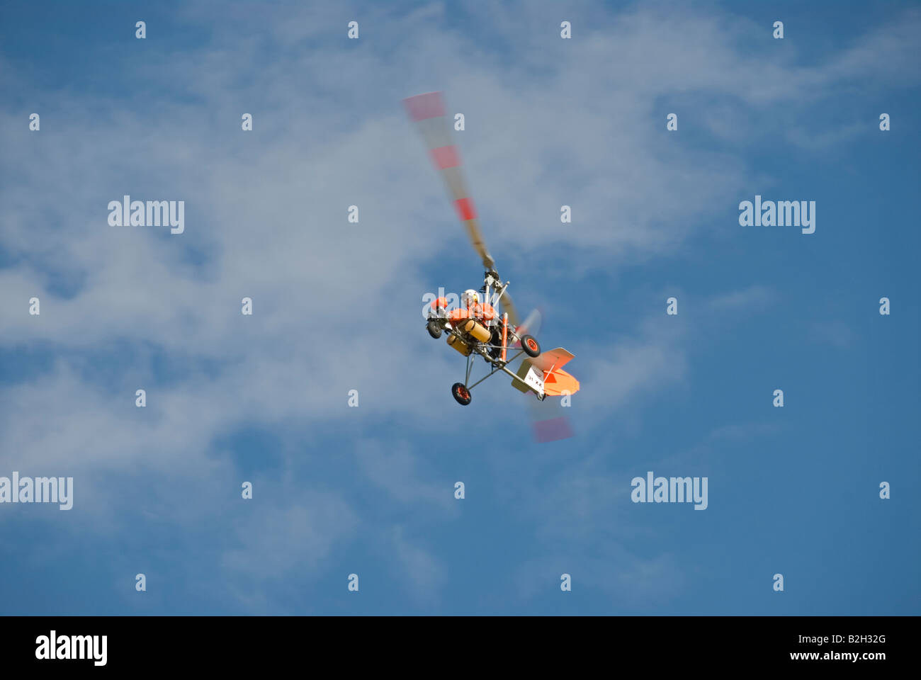 Stock photo of a single autogyro flying against a blue sky The photo was taken during a aviation dislplay in Estivol France Stock Photo