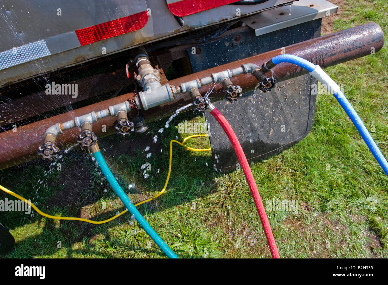 Colored water hoses attached to a water truck Stock Photo Alamy