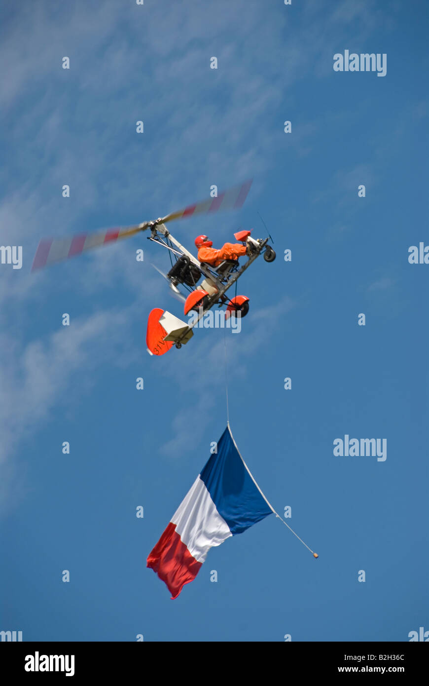 Stock photo of a single autogyro with the french flag flying beneath it Stock Photo