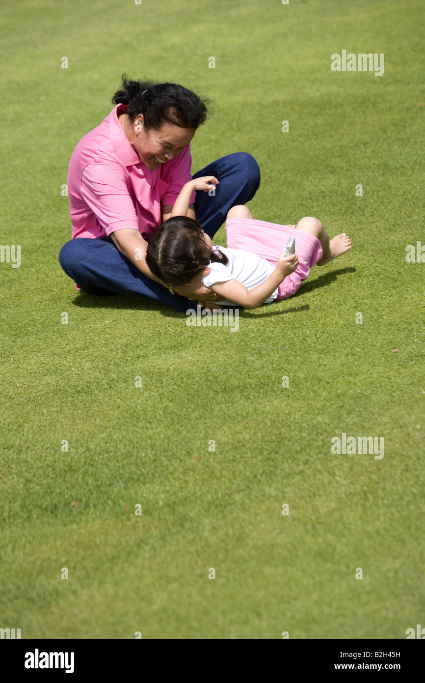 Senior woman with her granddaughter playing in a park Stock Photo - Alamy
