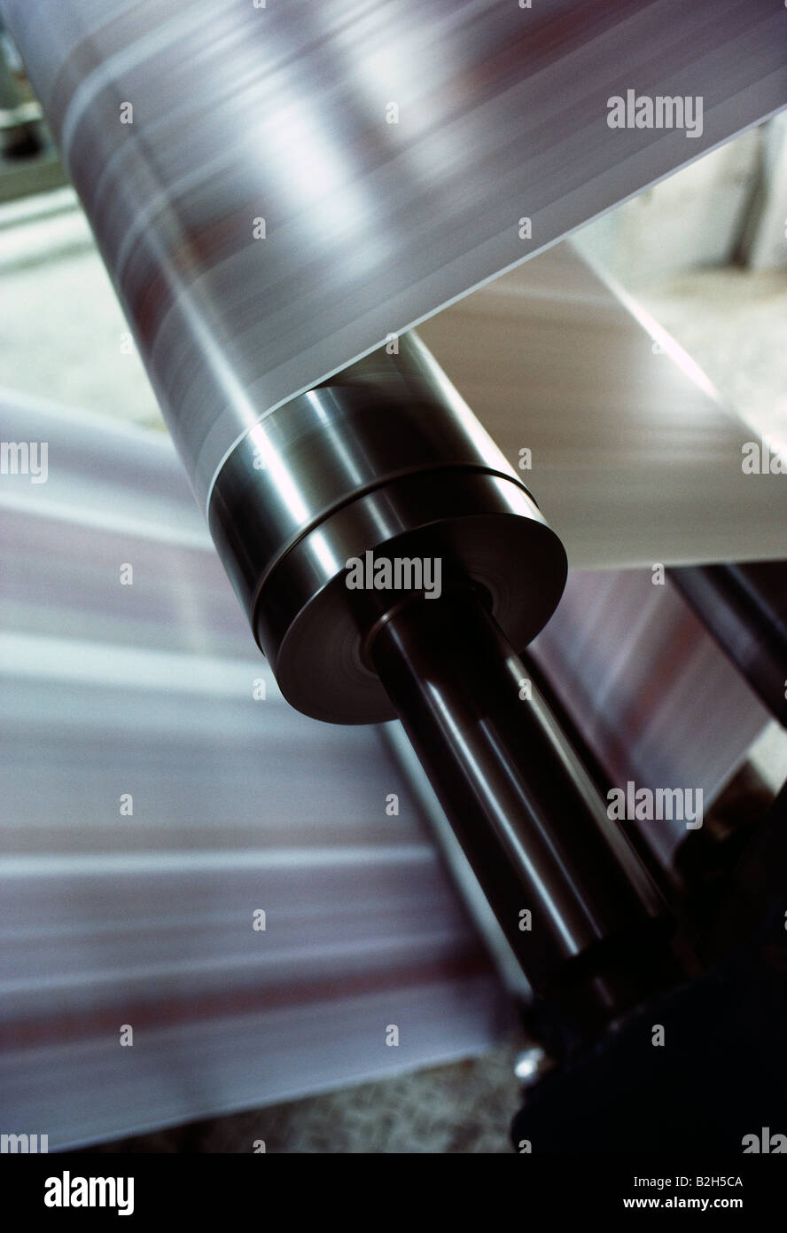 Abstract view of paper running through a web feed printing press Stock