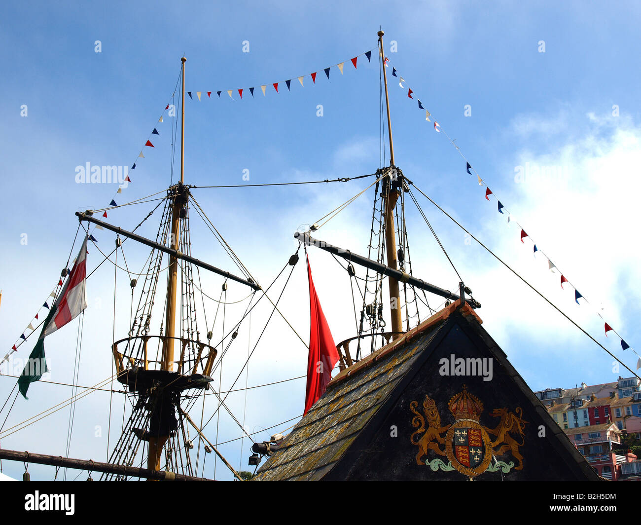 The masts, rigging and the coat of arms of the 'Golden Hind'replica at Brixham,The English Reviera,Devon,uk. Stock Photo