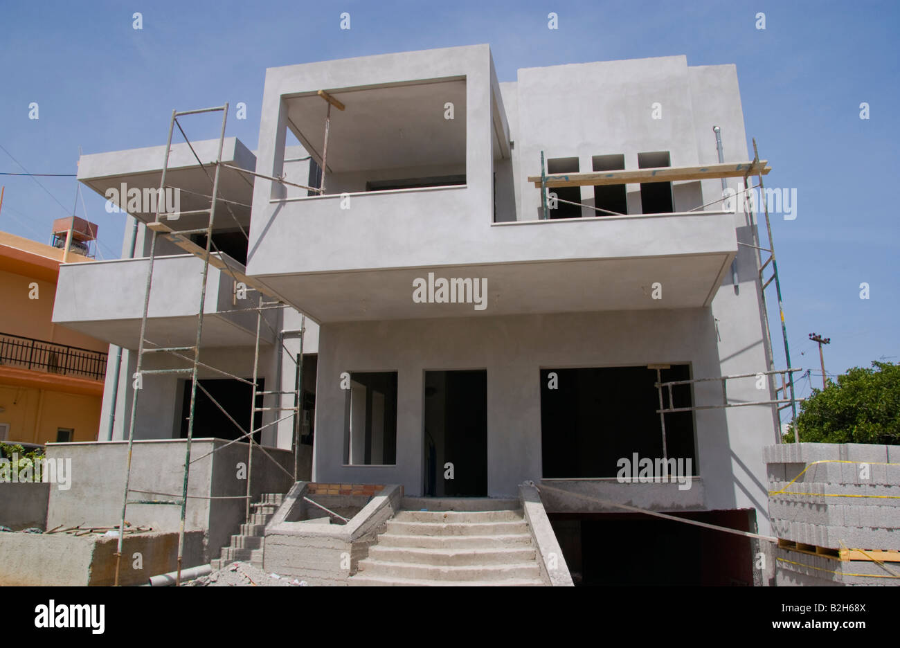 Exterior of holiday apartments under construction in Malia Old Town on the Greek Mediterranean island of Crete GR EU Stock Photo