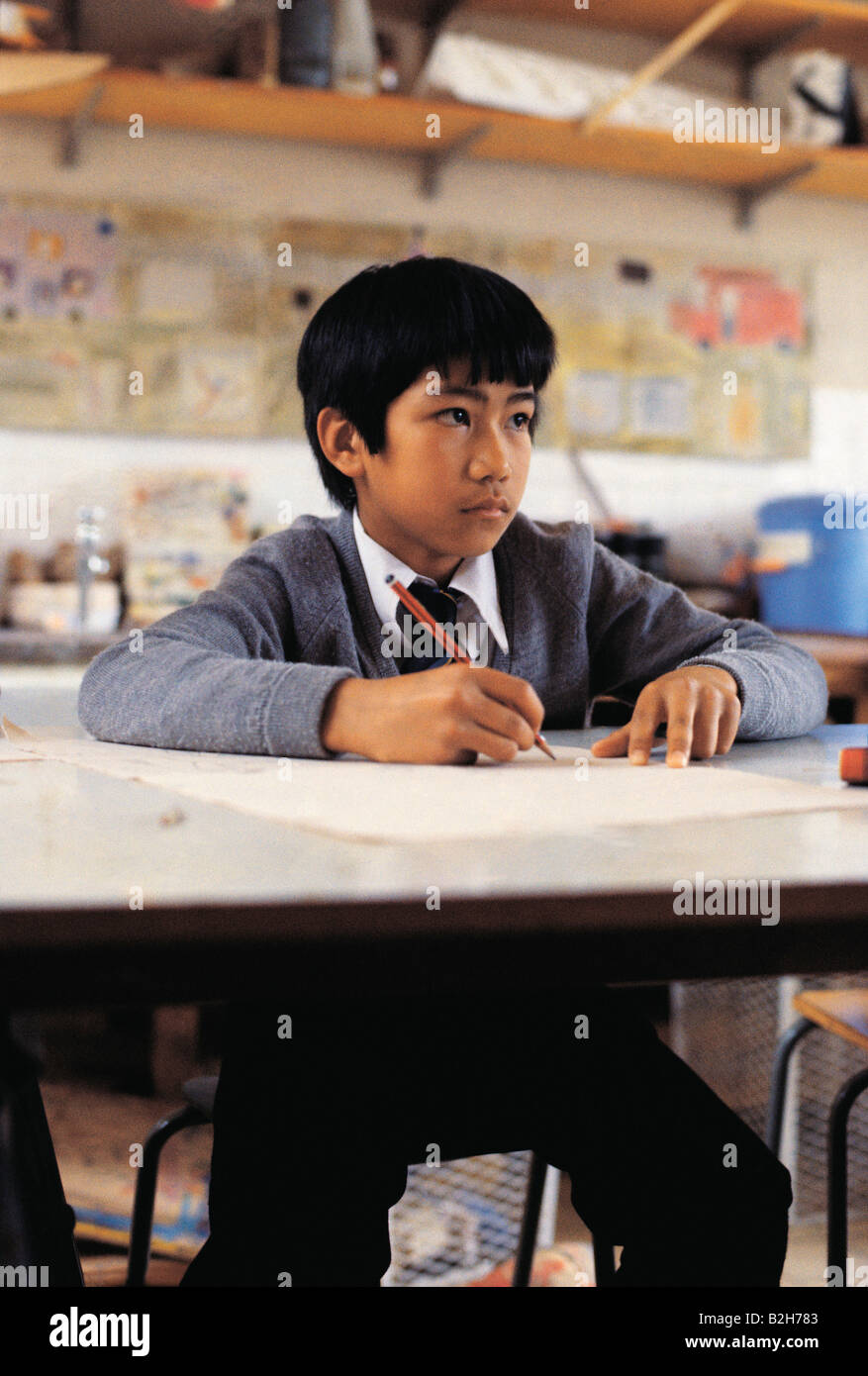 Front view of an Asian boy studying in classroom Stock Photo - Alamy