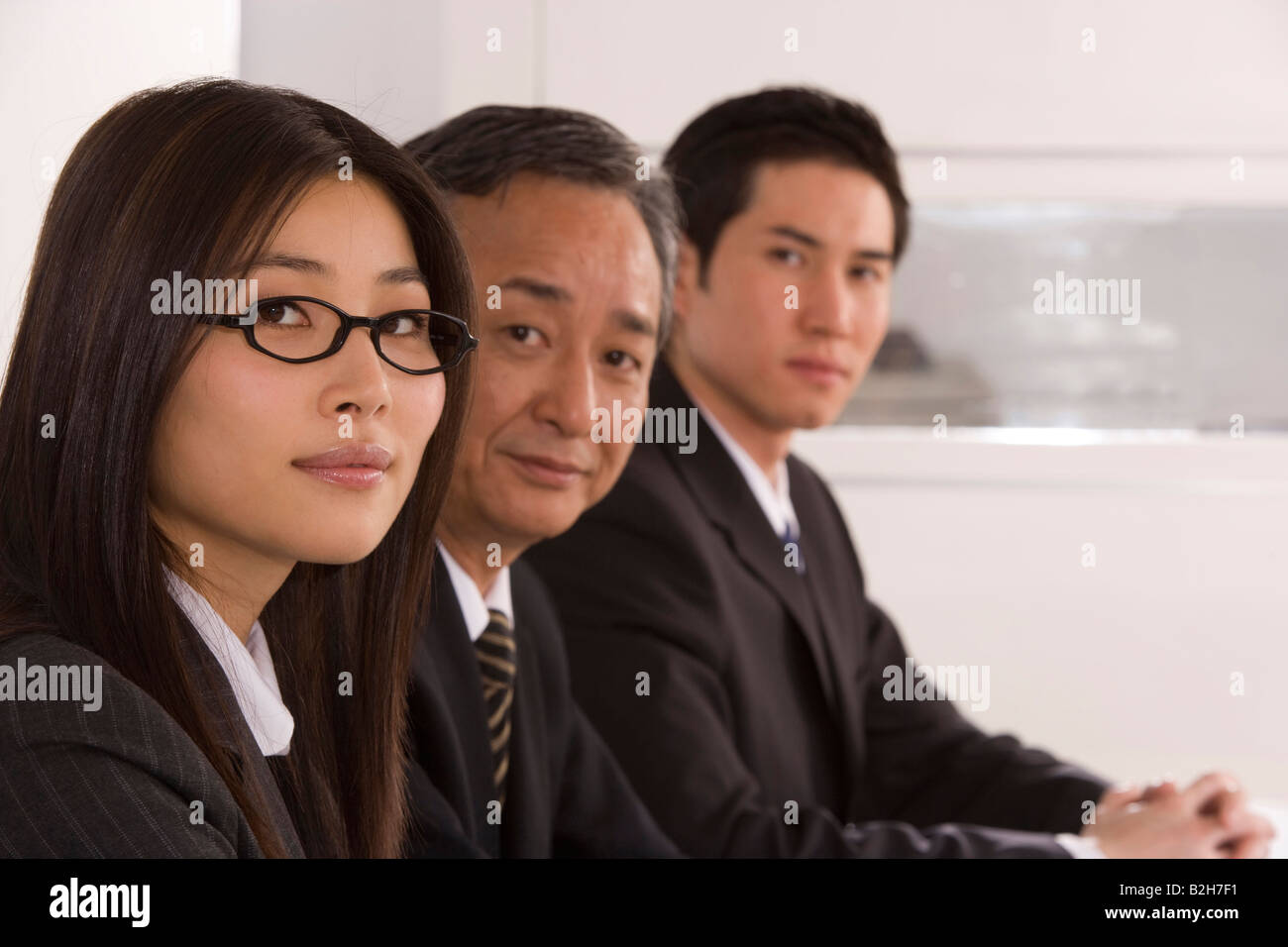 Three women sitting in row hi-res stock photography and images - Alamy