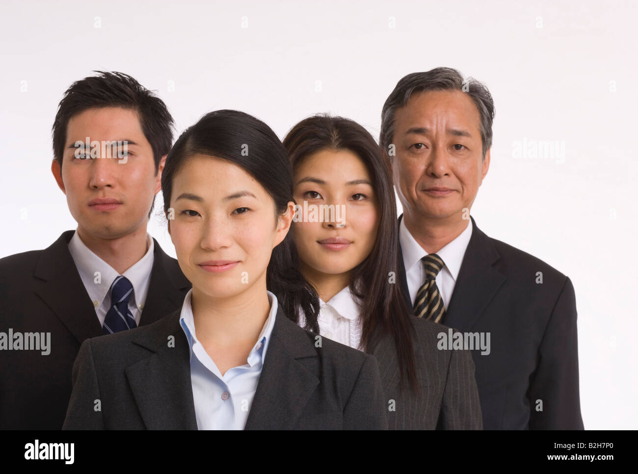 Portrait of two businessmen with two businesswomen standing side by ...