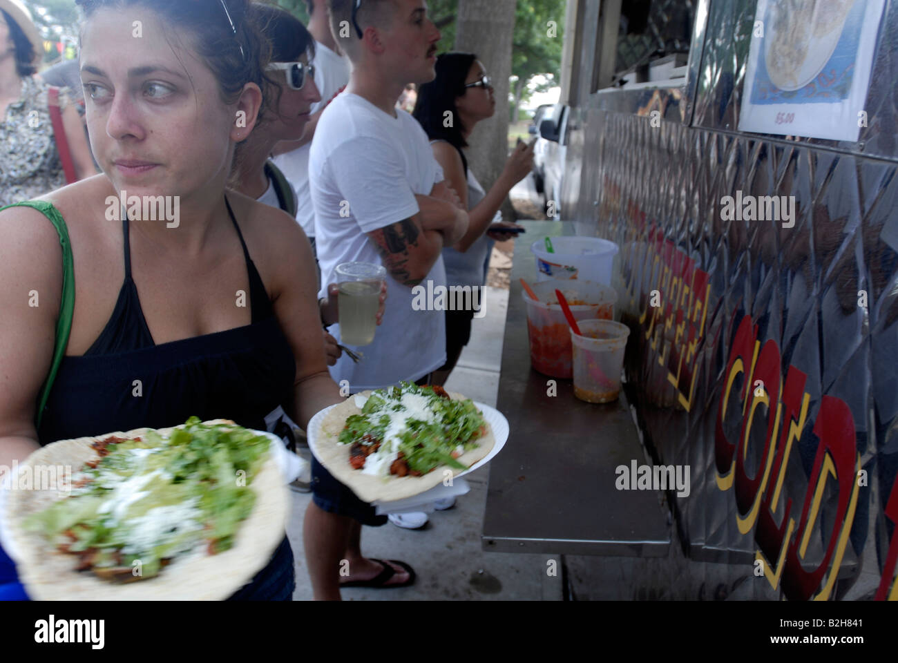 Customers with Mexican chalupas from the Latin food vendors in the Red Hook neighborhood of Brooklyn in New York Stock Photo