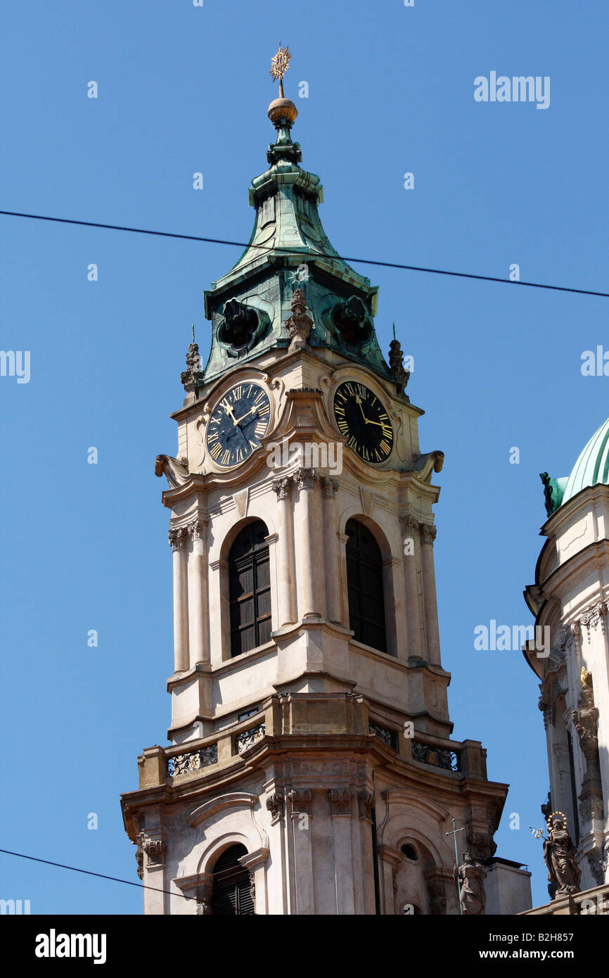 The clock and bell tower of St Nicolas Cathedral located in the Lesser Quarter in Prague Stock Photo