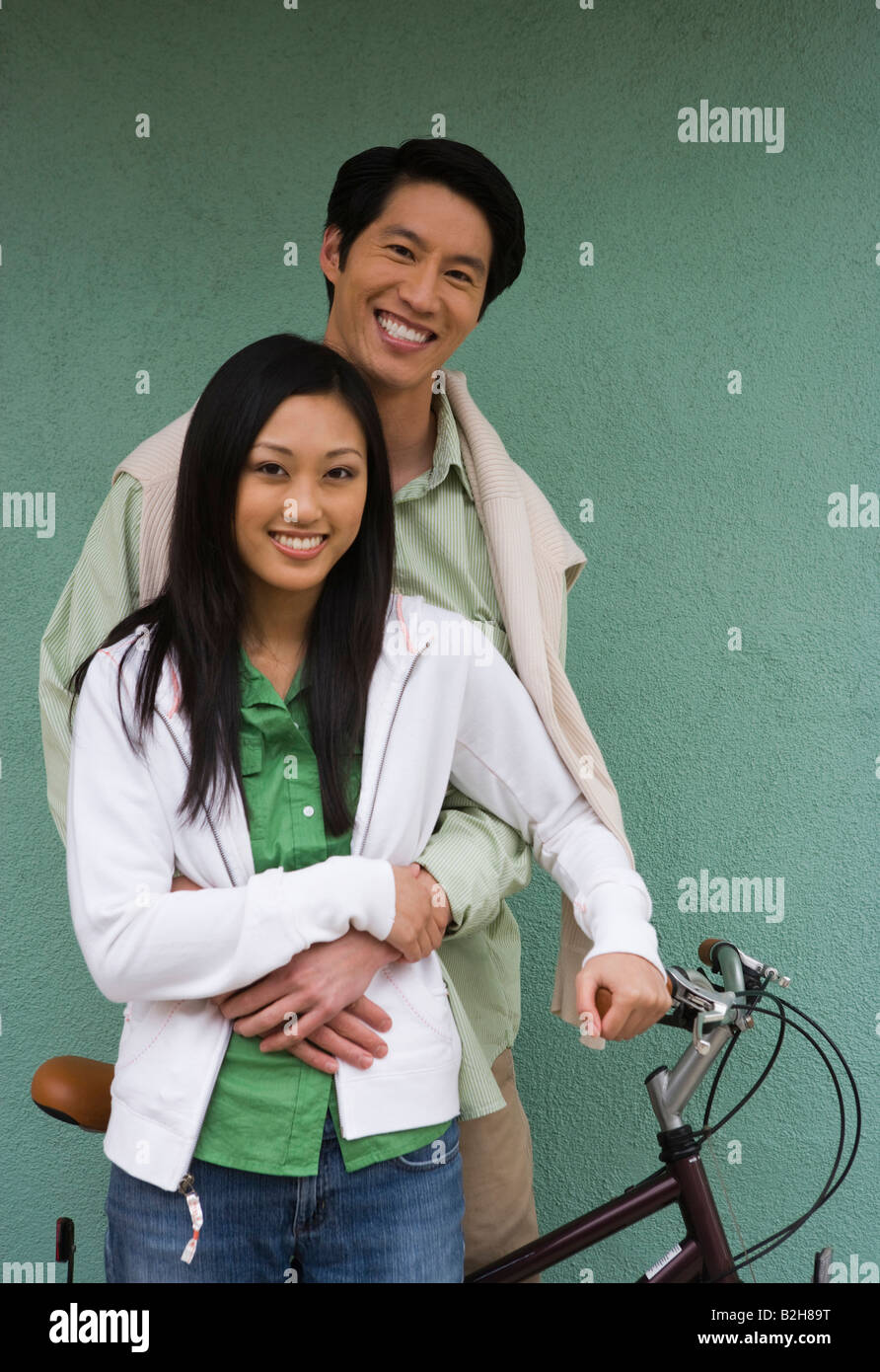 Mid adult man embracing a young woman from behind and smiling Stock ...