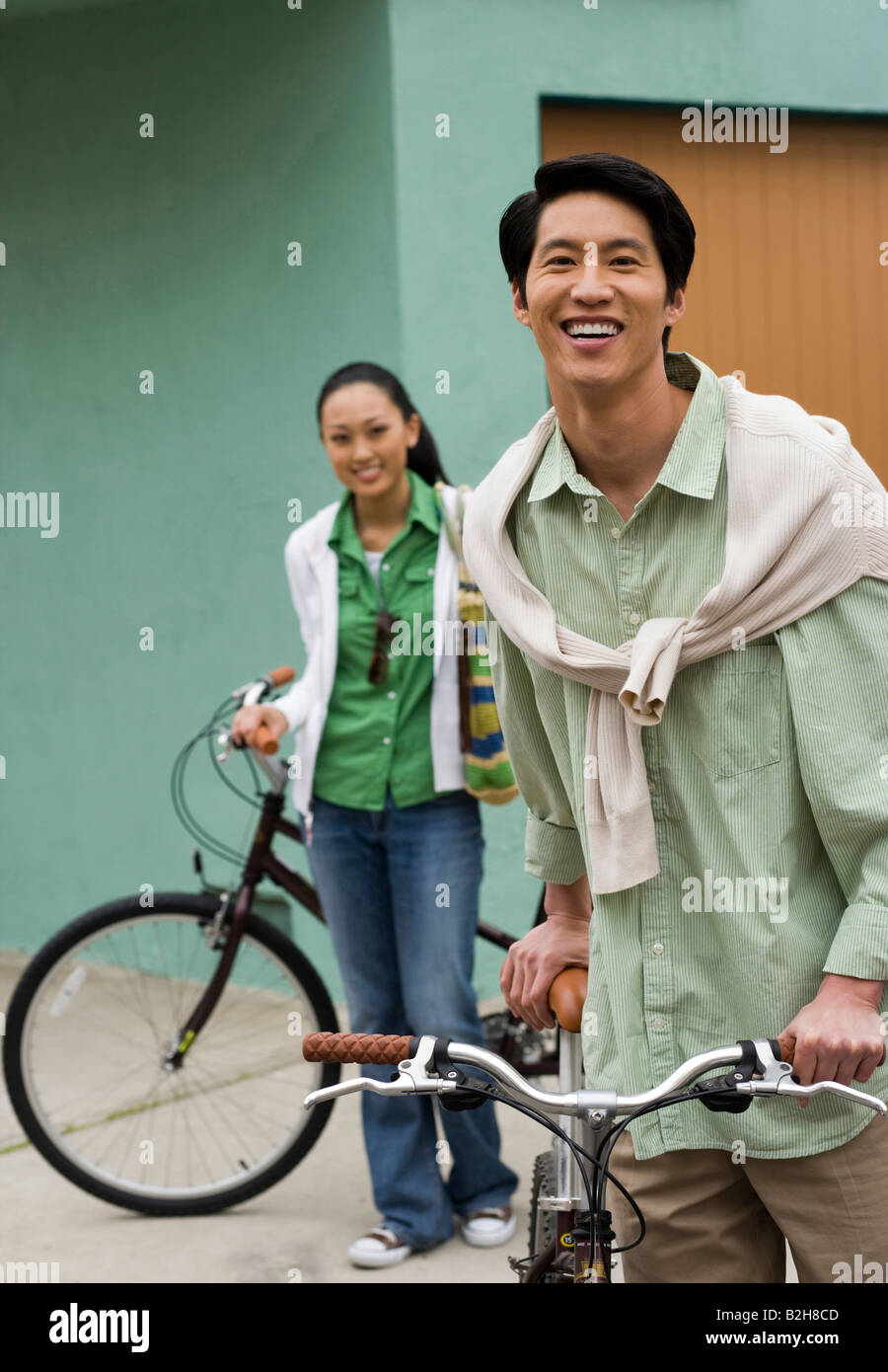 Portrait of a mid adult man smiling with a young woman standing in the ...