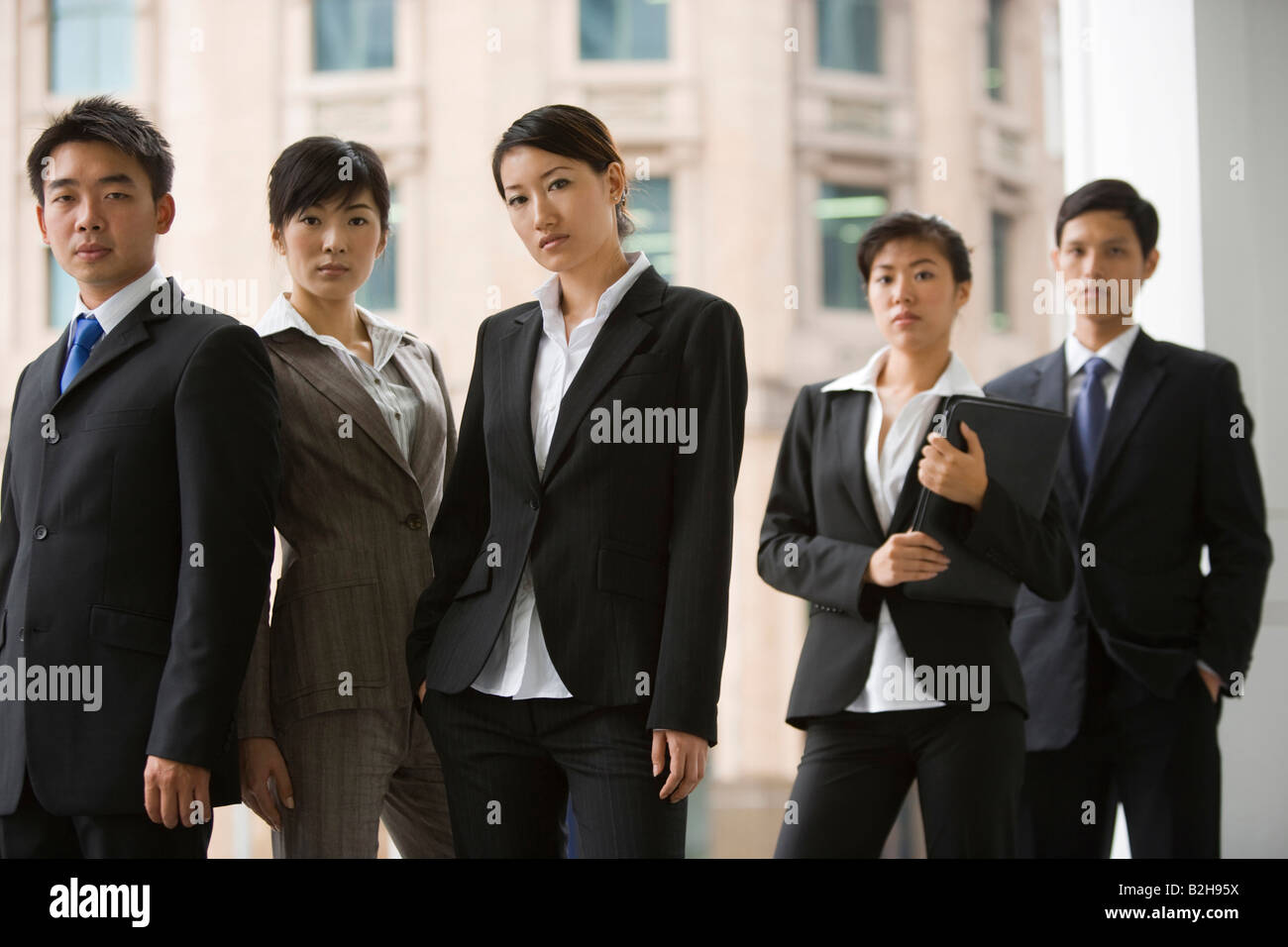 Portrait of five business executives standing together Stock Photo - Alamy