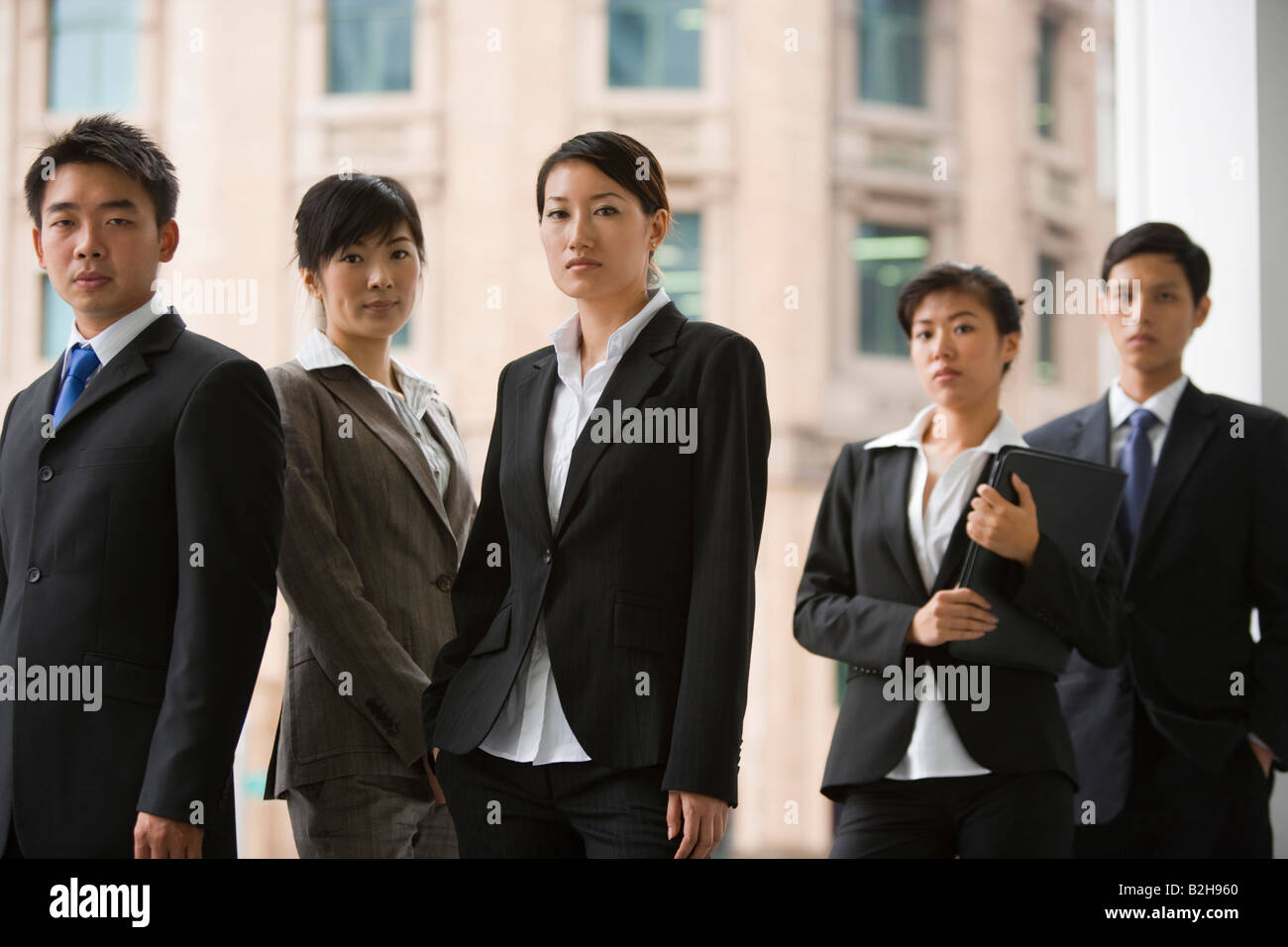 Portrait of five business executives standing together Stock Photo - Alamy