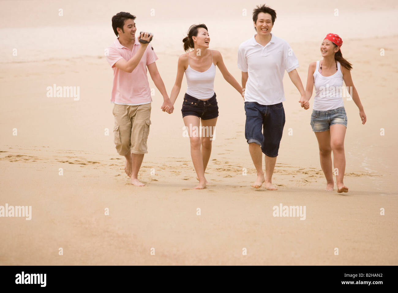 Asian couple holding hands walking hi-res stock photography and images ...