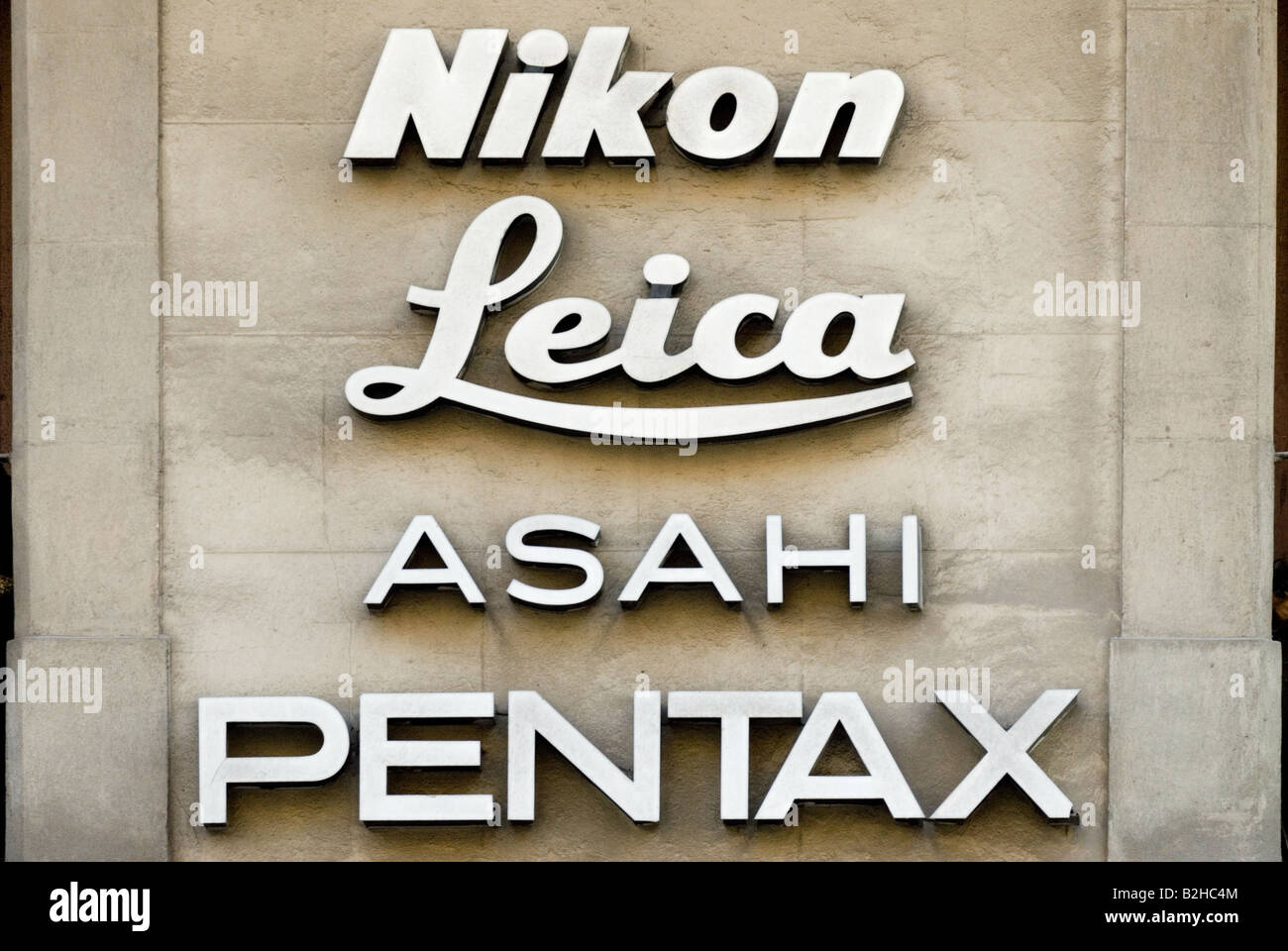 nikon leica asahi pentax sign in a wall barcelona Stock Photo