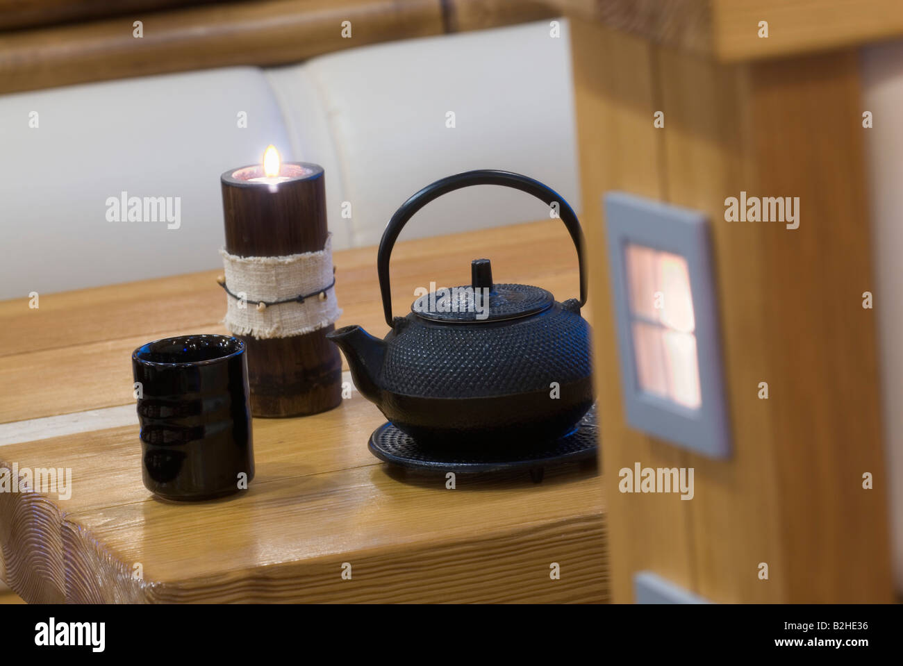 still life of asian teapot cup and candle Stock Photo