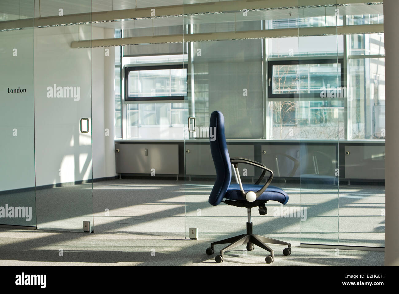 still of chair in empty office space Stock Photo - Alamy