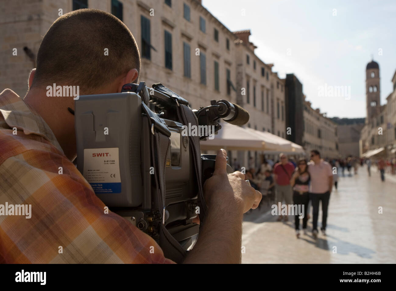 Professional TV Cameraman filming on the Stradun Dubrovnik Croatia Stock Photo