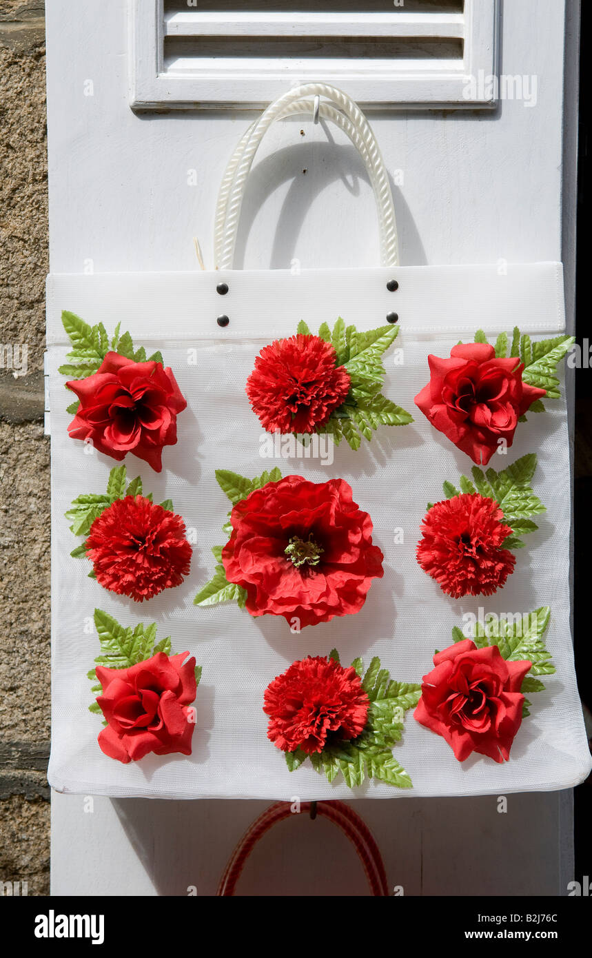 artificial red roses on white carry bag Stock Photo